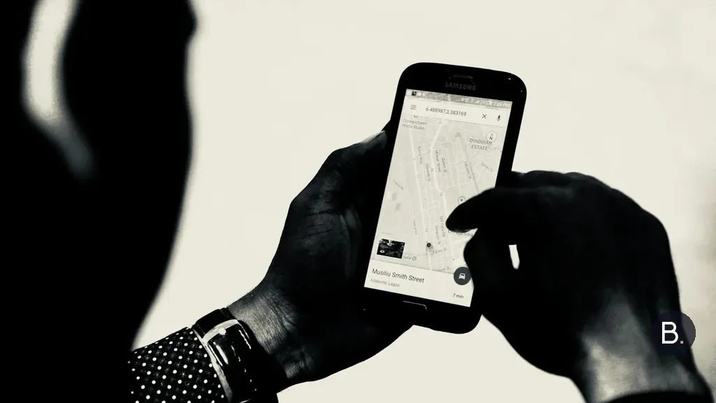 A person holding a phone with Google Maps open on the screen